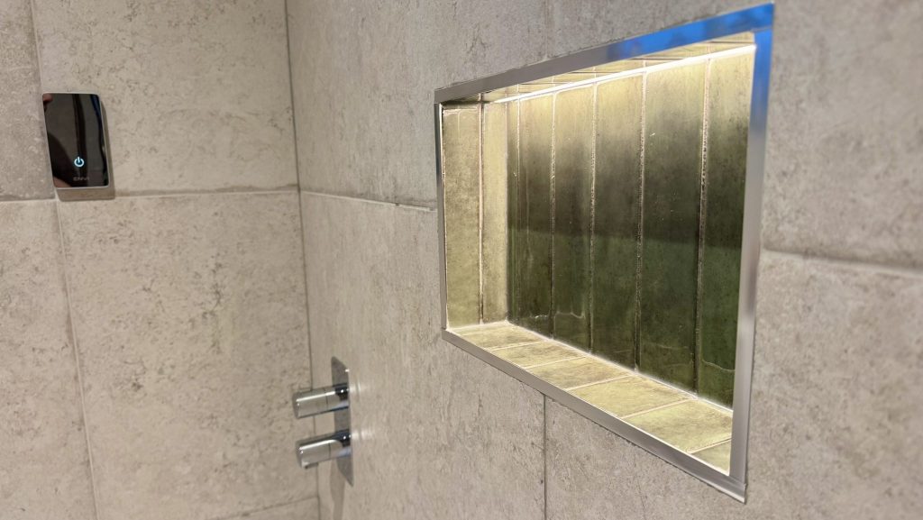 LED-lit shower niche beside the Triton ENVi digital controller
